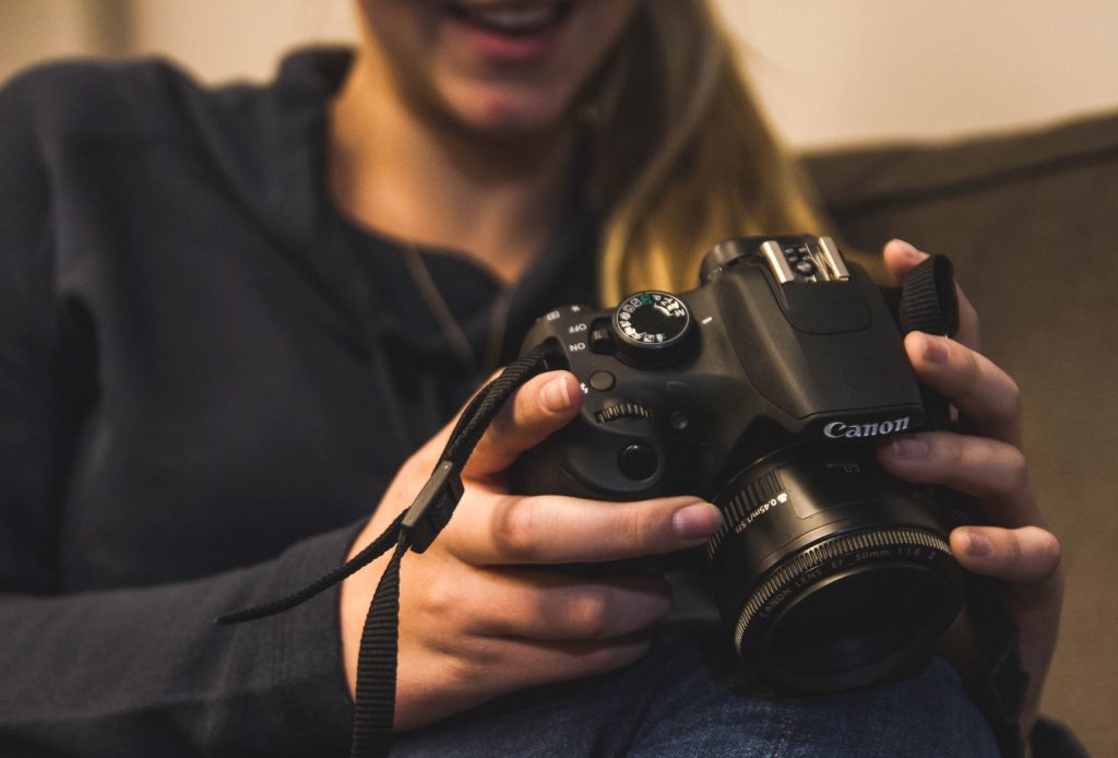 Woman holding camera.