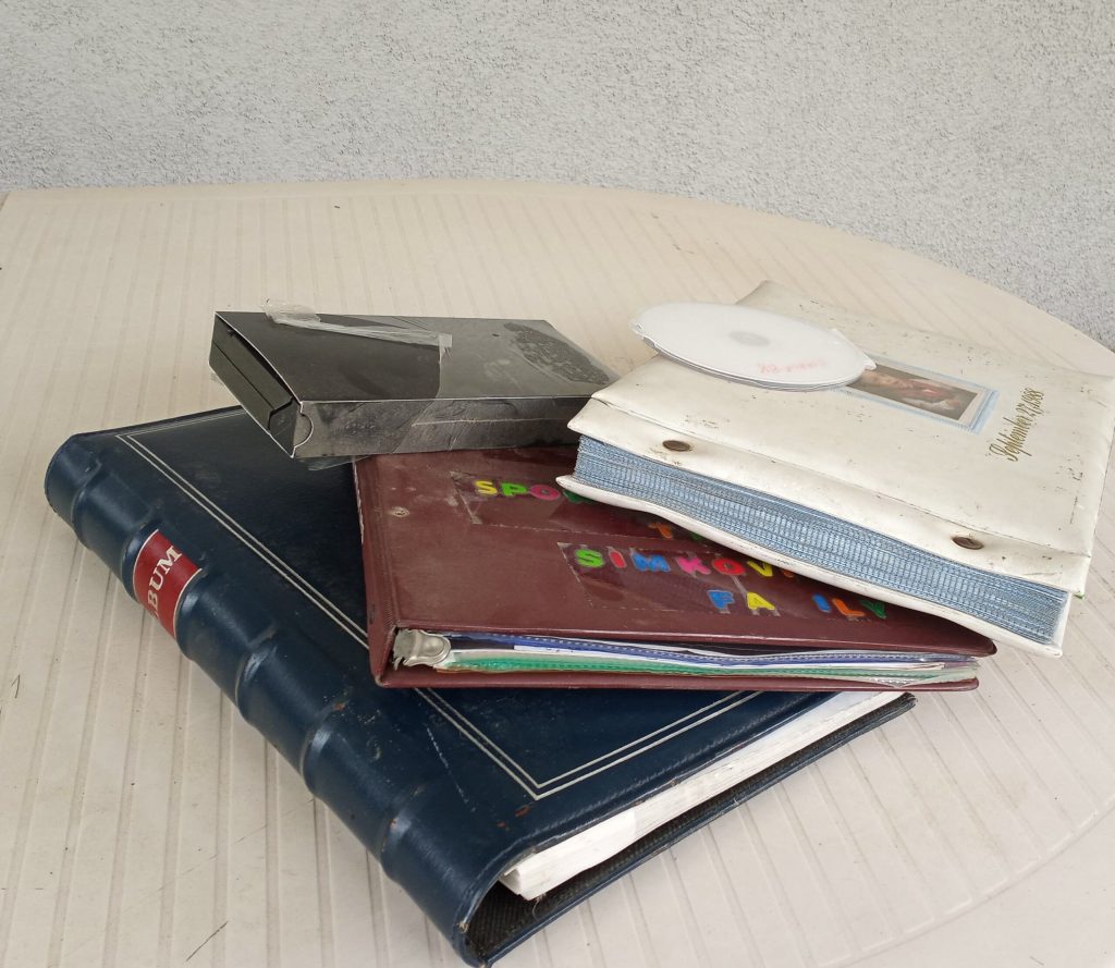 Photo albums, vhs tape and CD in a stack