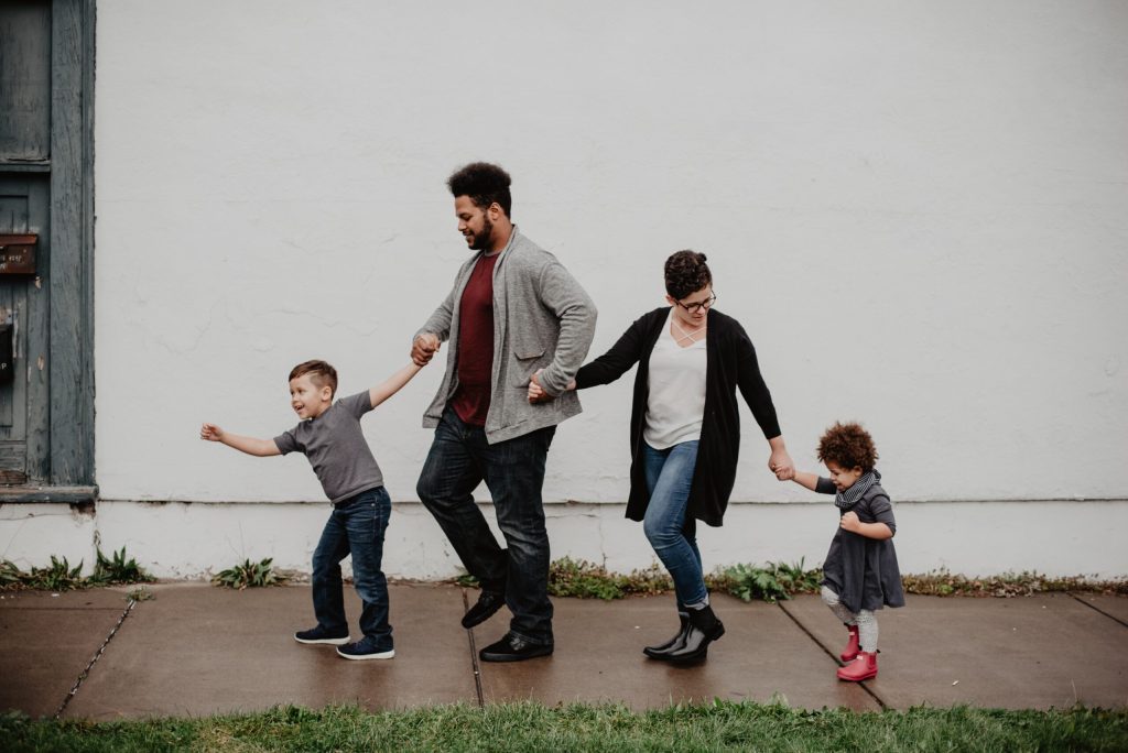 Boy, man, woman, girl holding hands