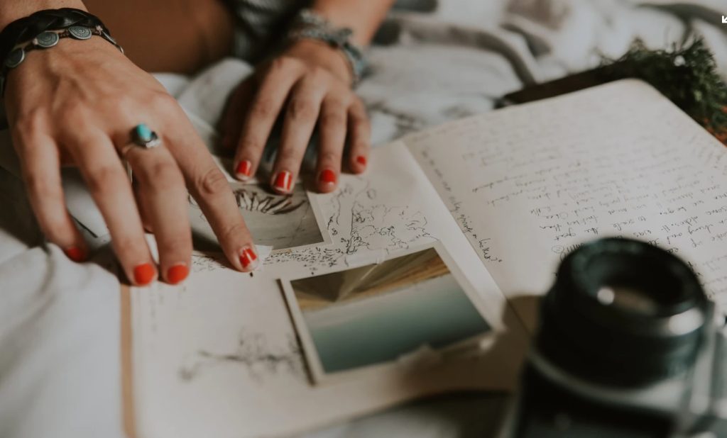 Woman's fingers on journal with picture