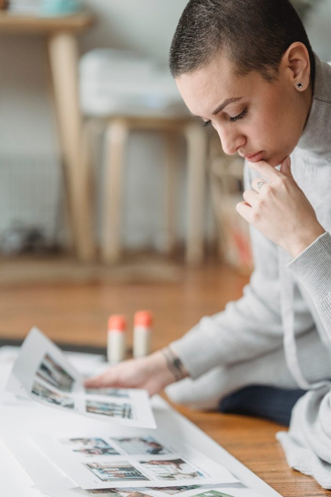 Woman looking at printed photos