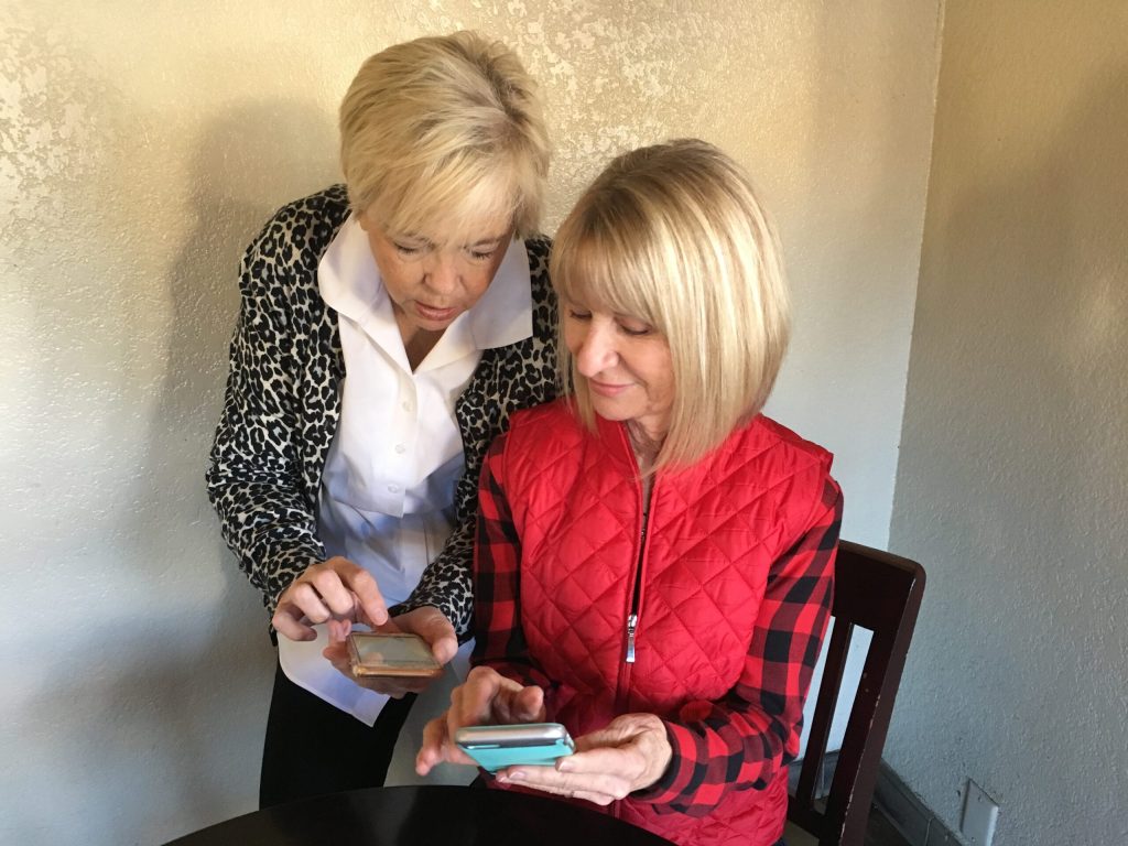 Two women looking at smartphones