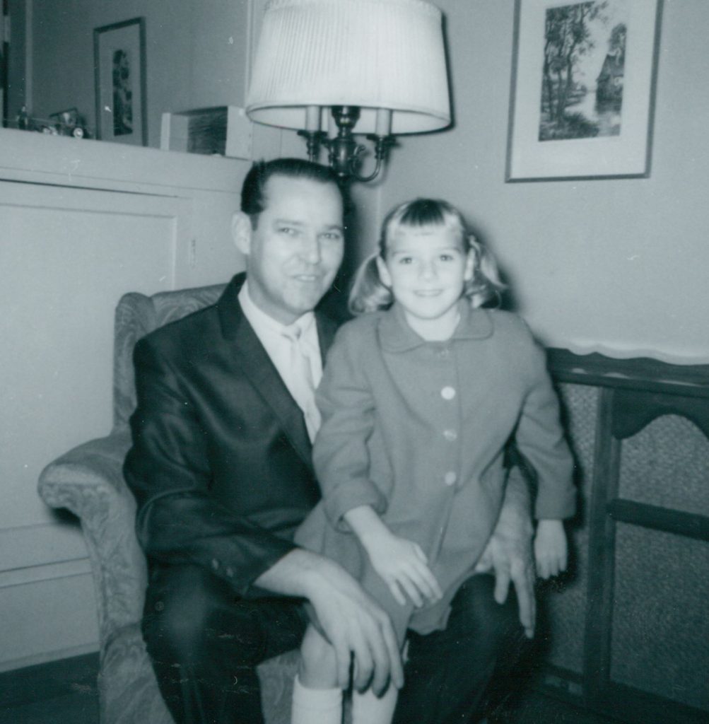 Man in suit with girl on lap, 1967