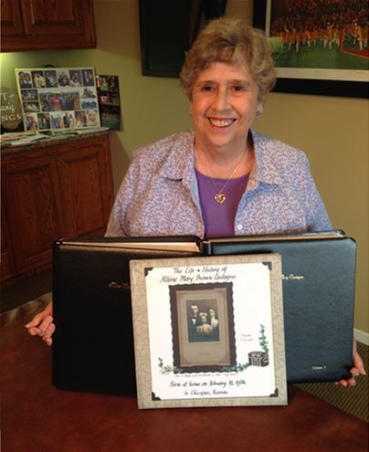 Woman posing with photo albums
