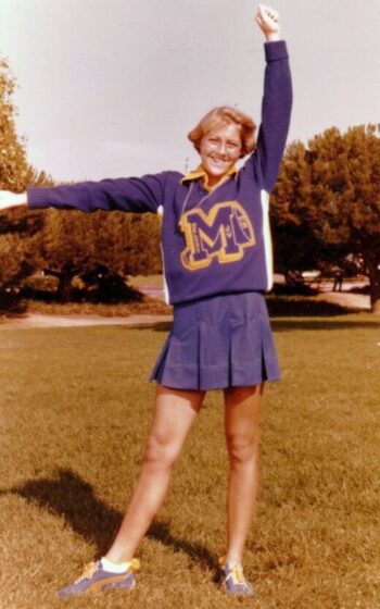 Young woman in cheer outfit circa 1970s