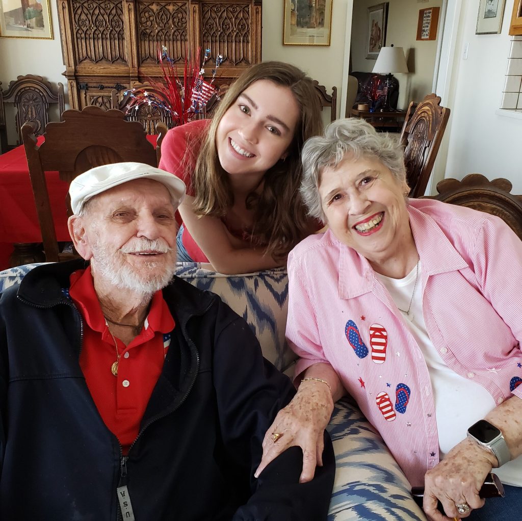 Elderly man, young woman in middle, elderly woman