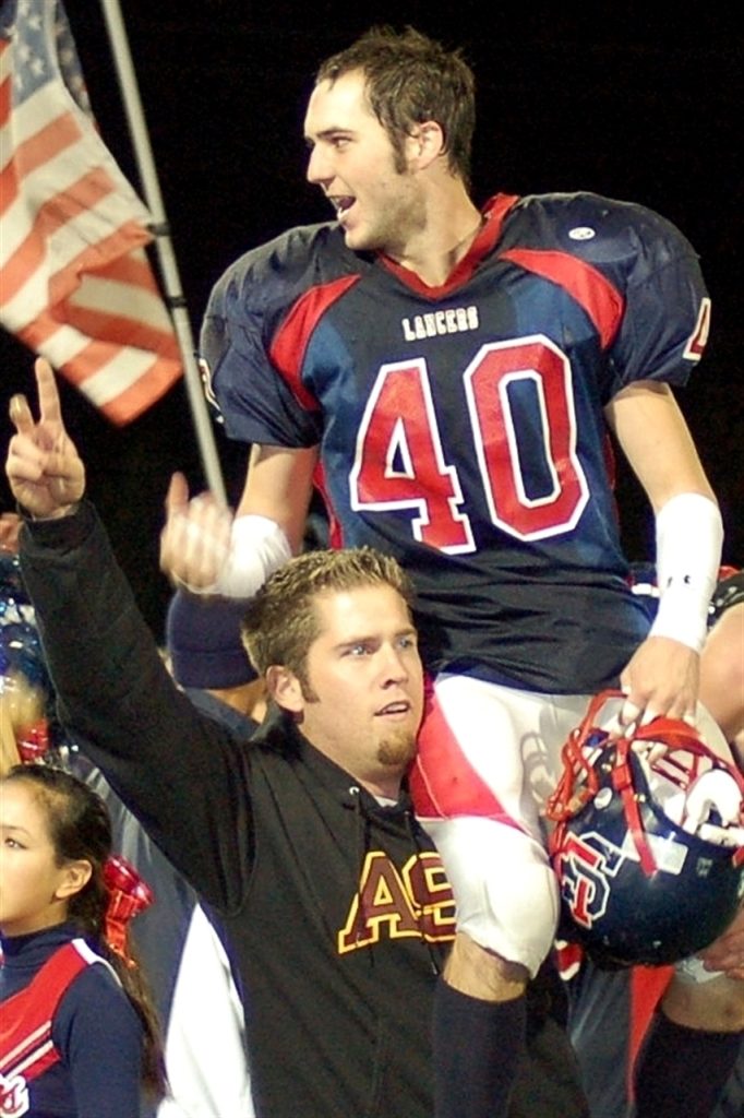 Football player lifted on someone's shoulders