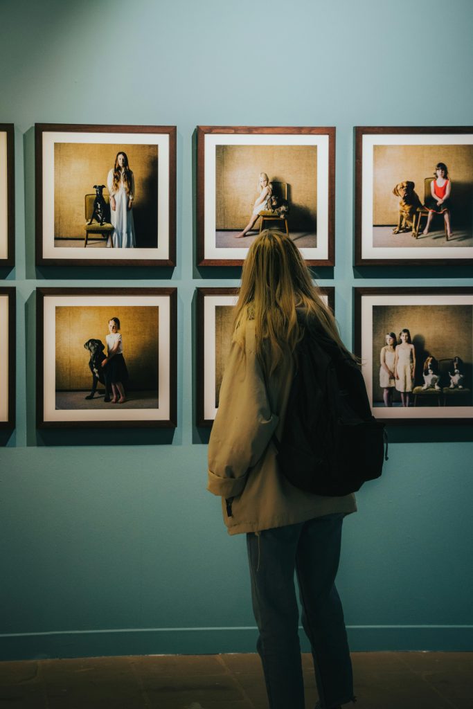 Woman looking at photos on wall