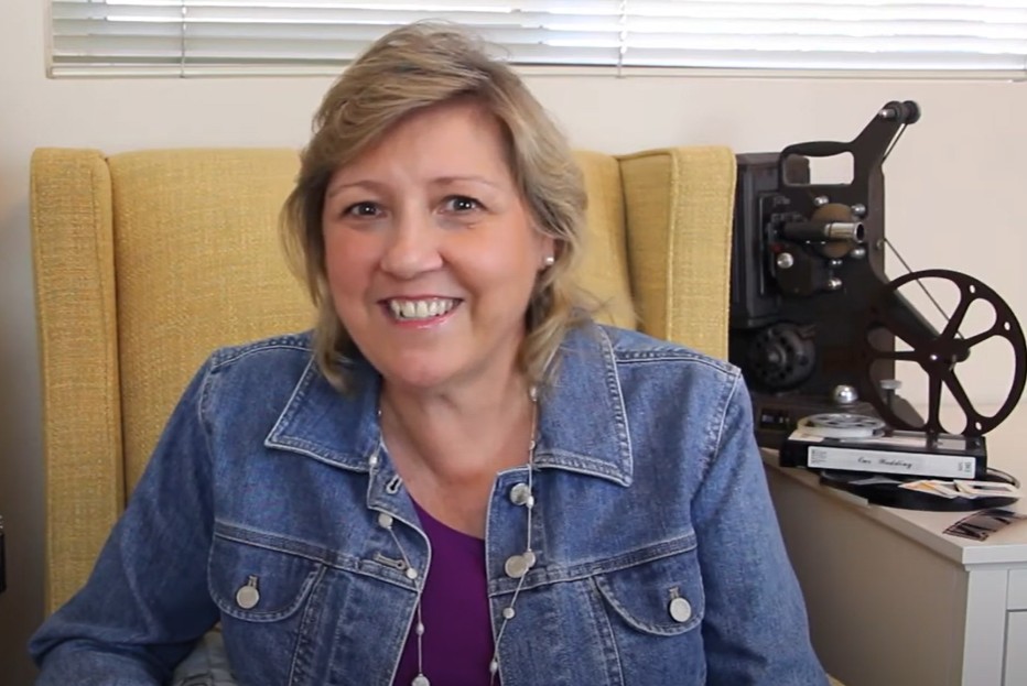 Woman smiling at camera wearing jeans jacket